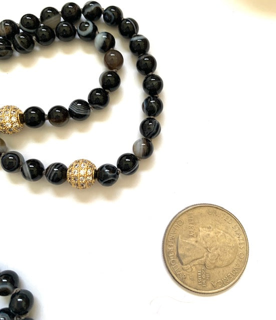 Sardonyx, also know as banded agate, 6mm knotted mala beads with pave cz gold plated accent beads, next to quarter for size comparison