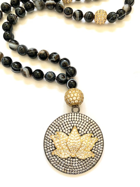 Sardonyx, also know as banded agate, 6mm knotted mala beads with a pave cz guru bead and large lotus flower pendant, close up
