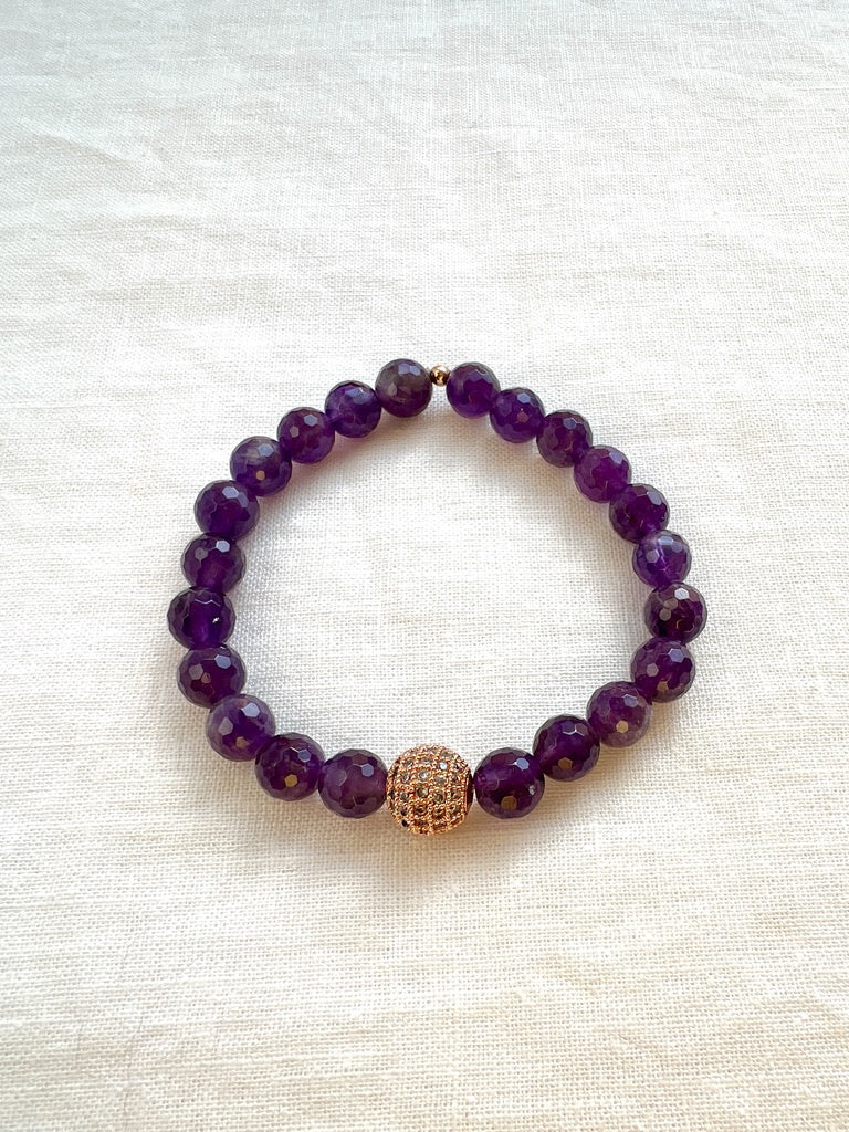 Inner Vision faceted amethyst stretch bracelet with a rose gold pave cubic zirconia bead on cream linen