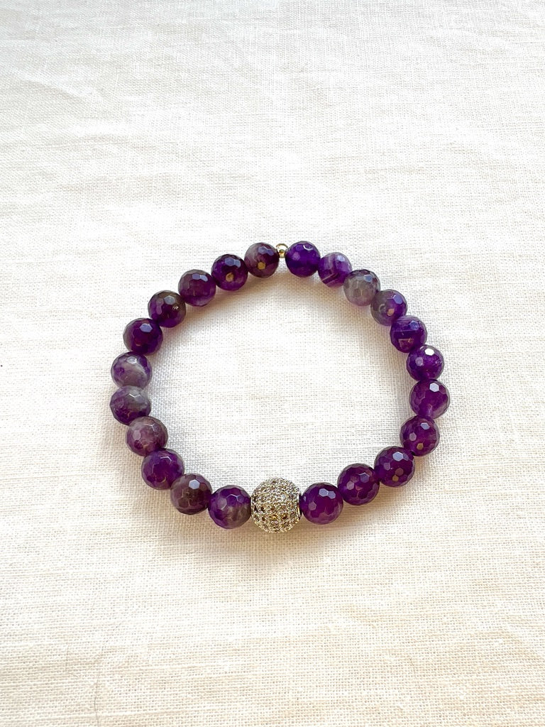 Inner Vision faceted amethyst stretch bracelet with a silver pave cubic zirconia bead on cream linen