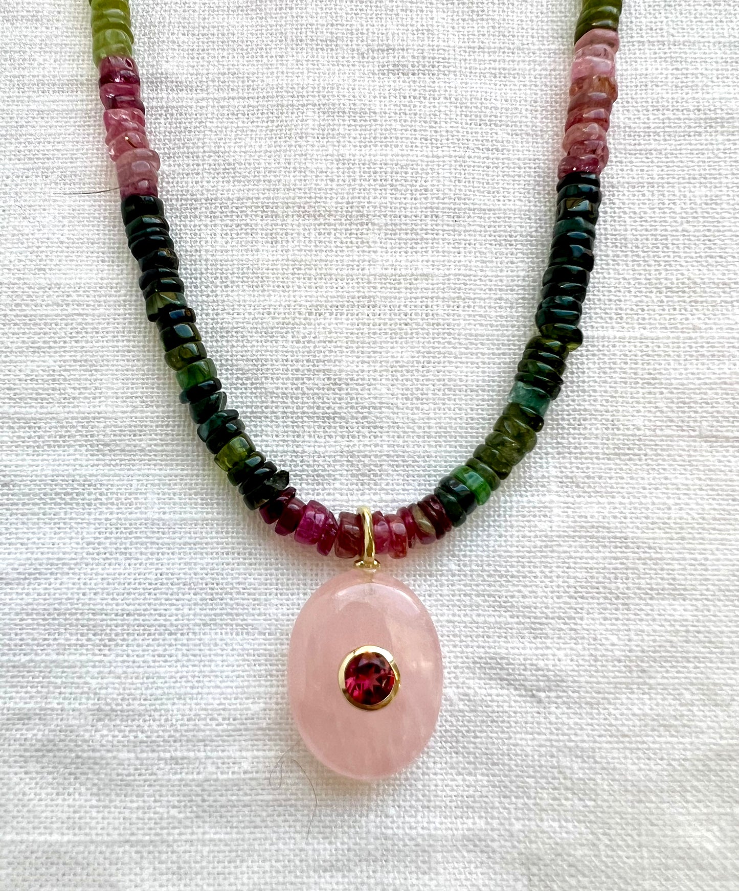 Rose quartz pendant in 18kt gold vermeil with a bezel set garnet on a strand of tourmaline