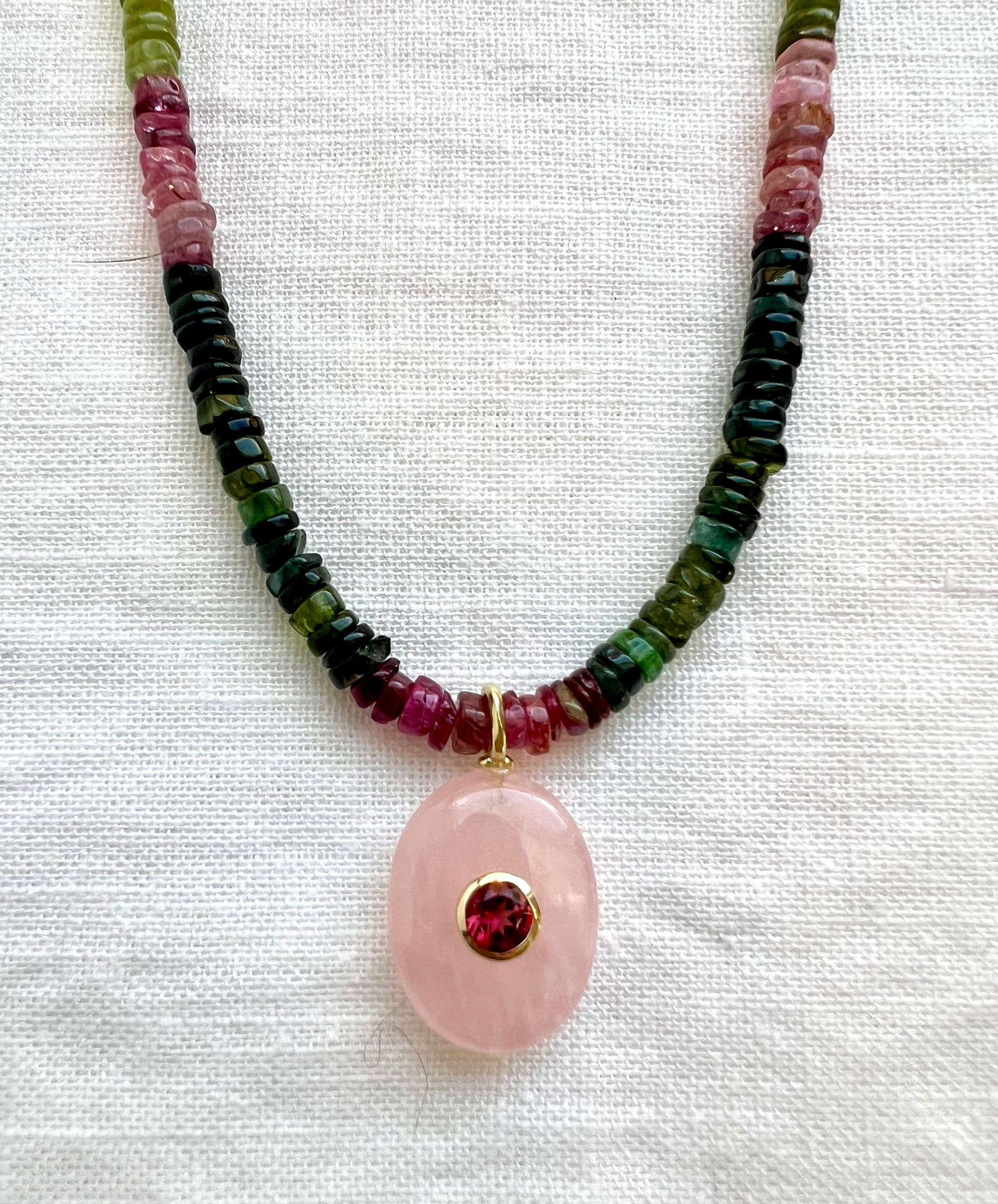Rose quartz pendant in 18kt gold vermeil with a bezel set garnet on a strand of tourmaline