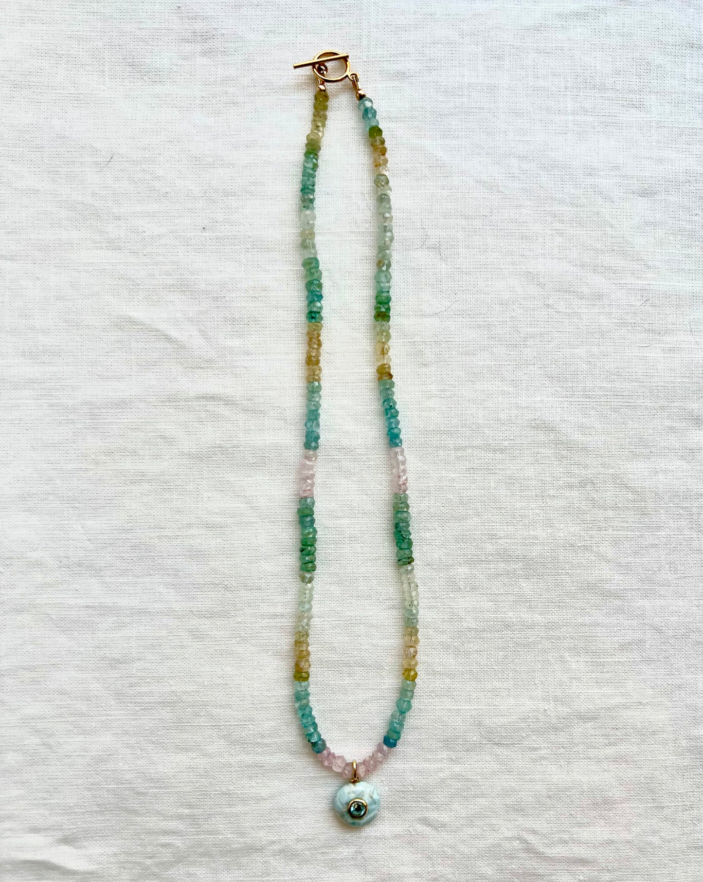 Multi beryl beaded necklace in aquamarine, morganite and golden beryl with a larimar pendant