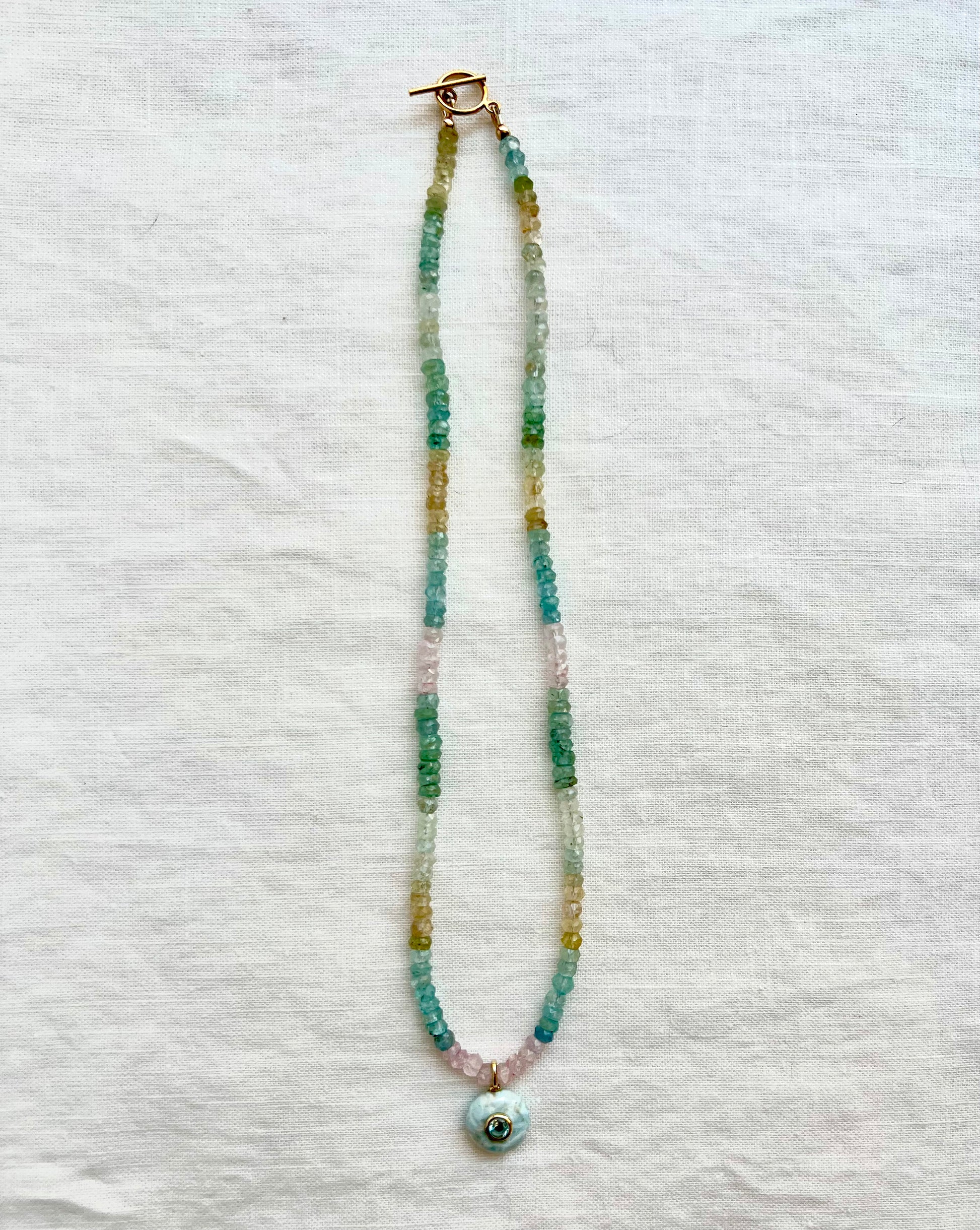Multi beryl beaded necklace in aquamarine, morganite and golden beryl with a larimar pendant