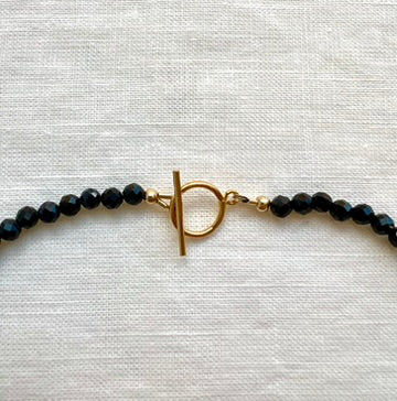 Dark blue sapphire bead necklace showing the blue flash of the labradorite pendant