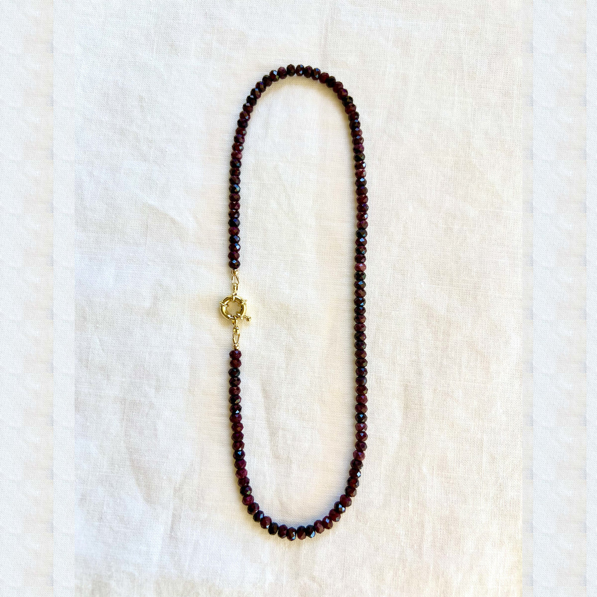 The garnet strand with the flower pendant removed, showing the gold filled clasp worn on its own