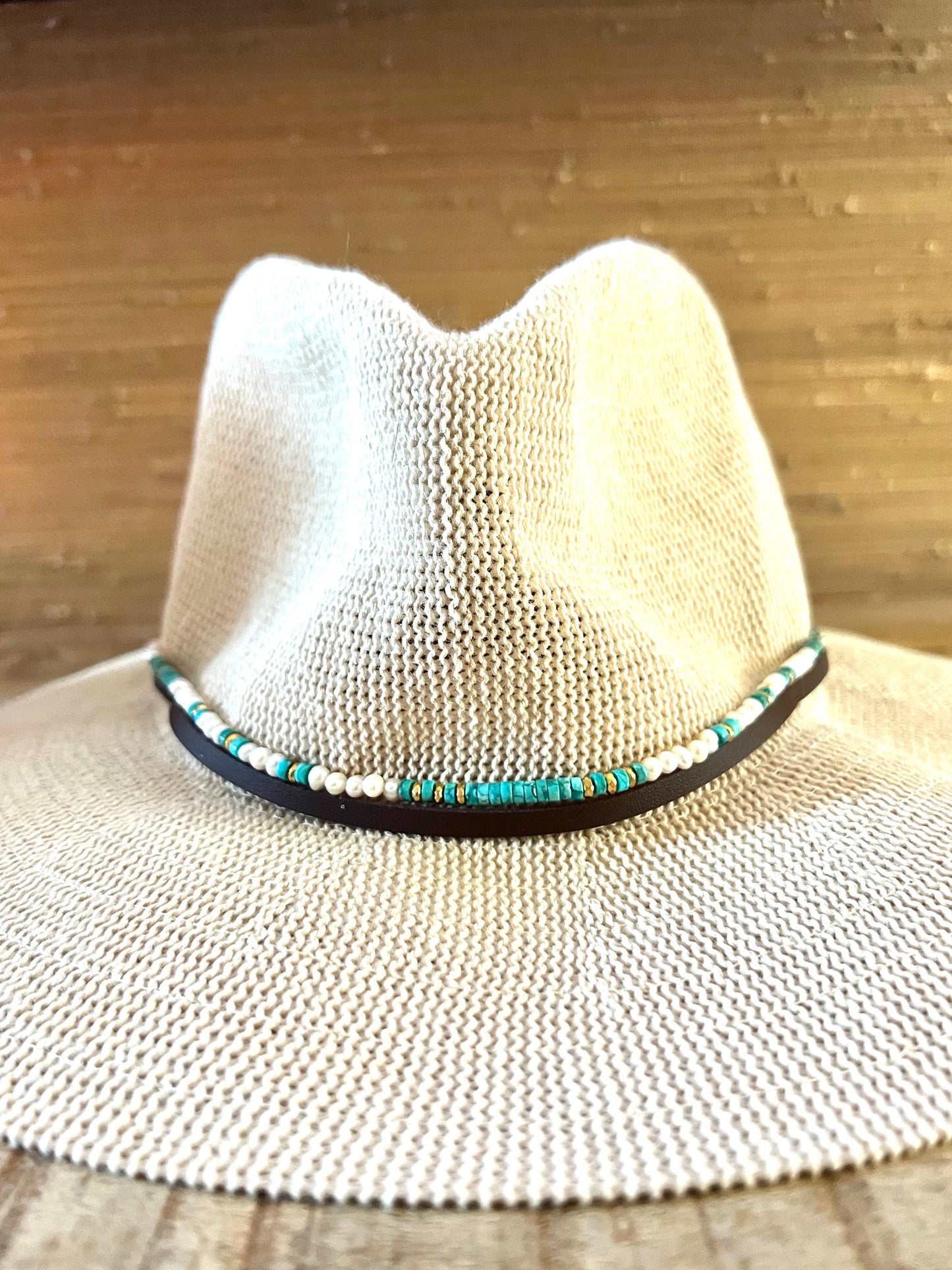Wide brim pale woven sun hat with the Arizona turquoise, freshwater pearl and gold hematite band fitted around the crown.