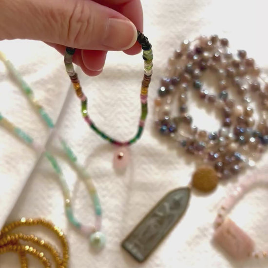 Video of the ombre tourmaline necklace turning in the light to show the pink, green and blue beads and the rose quartz and garnet pendant