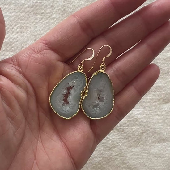 Video of the pale green agate slice geode earrings turning in the light