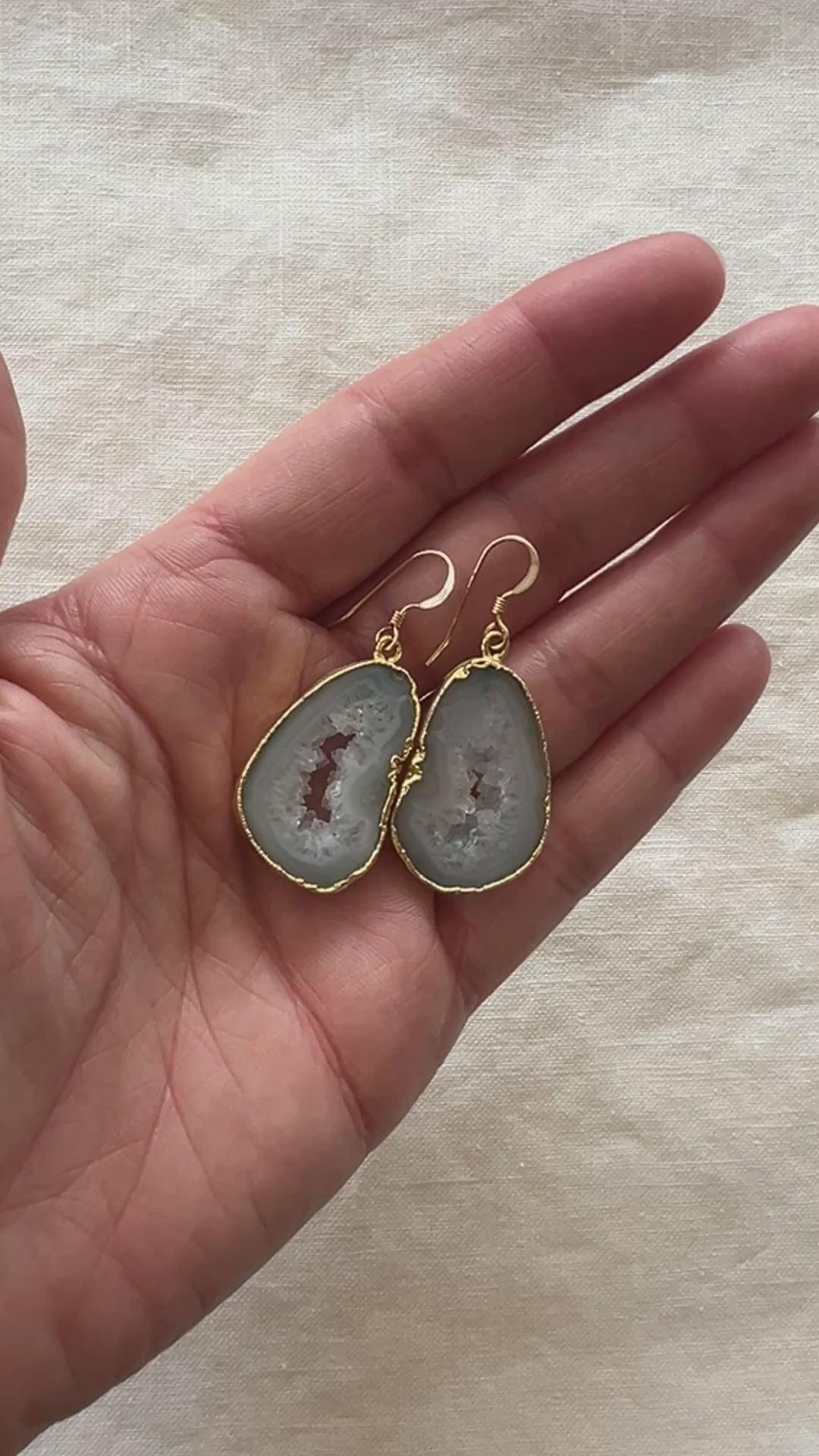 Video of the pale green agate slice geode earrings turning in the light