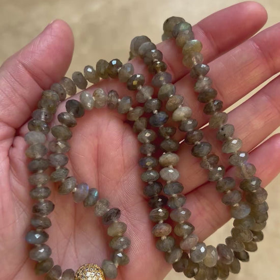 Video of the Emberlight labradorite mala turning in the light to show the blue flash in the faceted beads