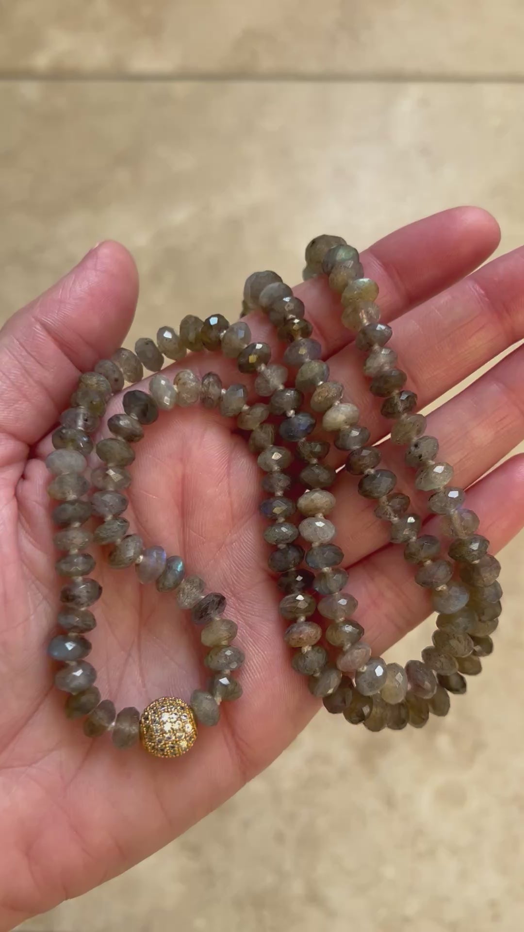 Video of the Emberlight labradorite mala turning in the light to show the blue flash in the faceted beads