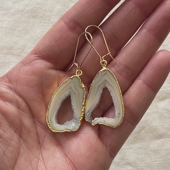 Video of the grey open geode agate slice earrings turning in the light