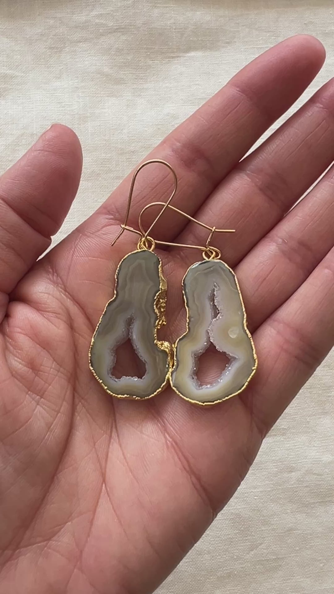 Video of the cream and beige agate slice geode earrings turning in the light