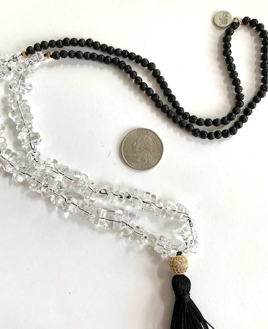 Tassel necklace with clear quartz and black lava beads, pave cz gold plated guru bead, black silk tassel, pictured next to us quarter for size comparison