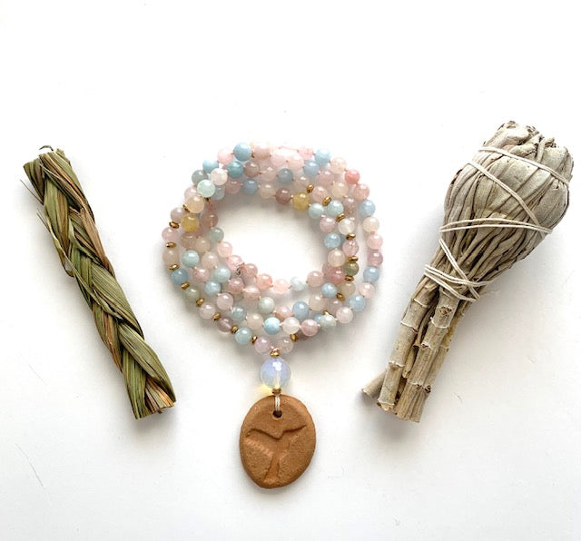 morganite mala beads , hummingbird terracotta oil diffuser pendant with sage bundles in picture