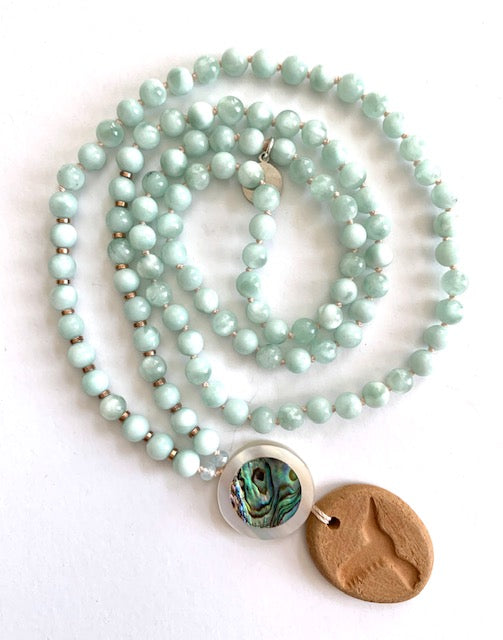 green Angelite mala beads with a mother of pearl guru bead and hummingbird oil diffuser terracotta pendant 