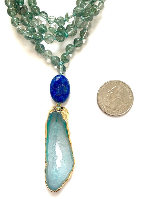 phantom quartz knotted mala beads, 6mm, oval lapis lazuli guru bead, green agate pendant, next to a quarter for size comparison