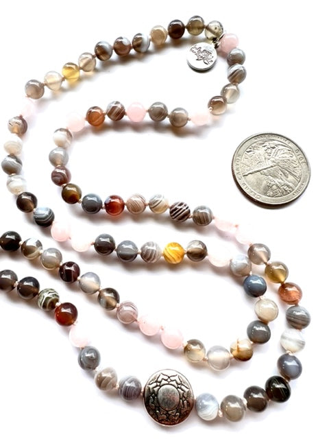 botswana agate and rose quartz knotted mala beads, pewter  lotus beads and a quarter for size comparison