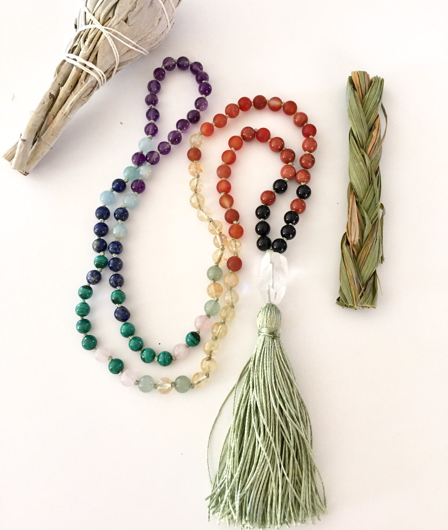 chakra balancing mala with multiple gemstones and green tassel, quartz guru bead