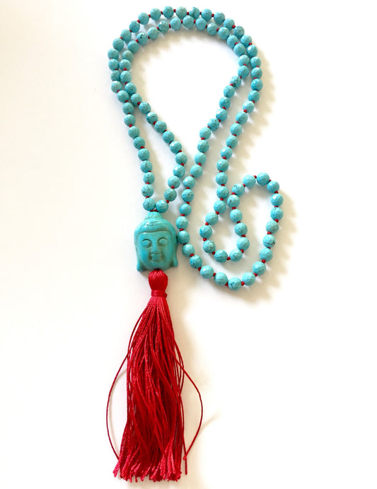Turquoise magnesite mala with a carved Buddha head guru bead and a long red silk tassel