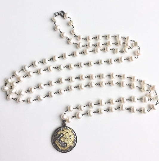 Freshwater pearl rosary chain necklace coiled with a dark pave Om medallion pendant