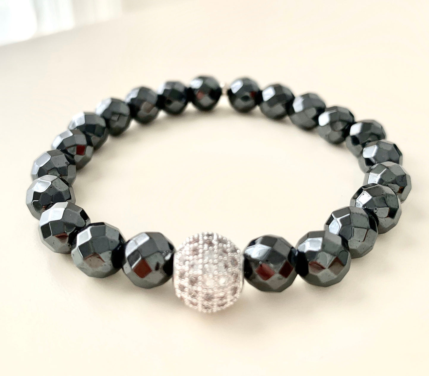 8mm faceted hematite bracelet with pave cz guru bead