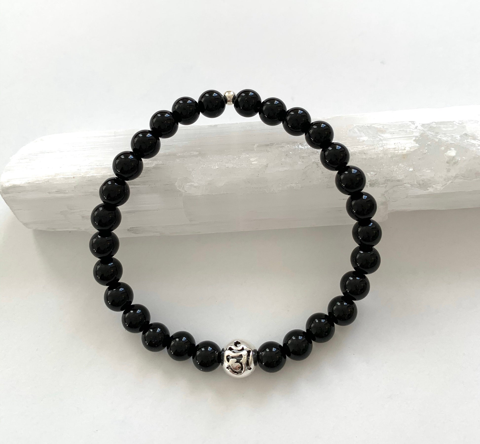 black onyx beaded bracelet with pierced sterling silver Om accent bead  