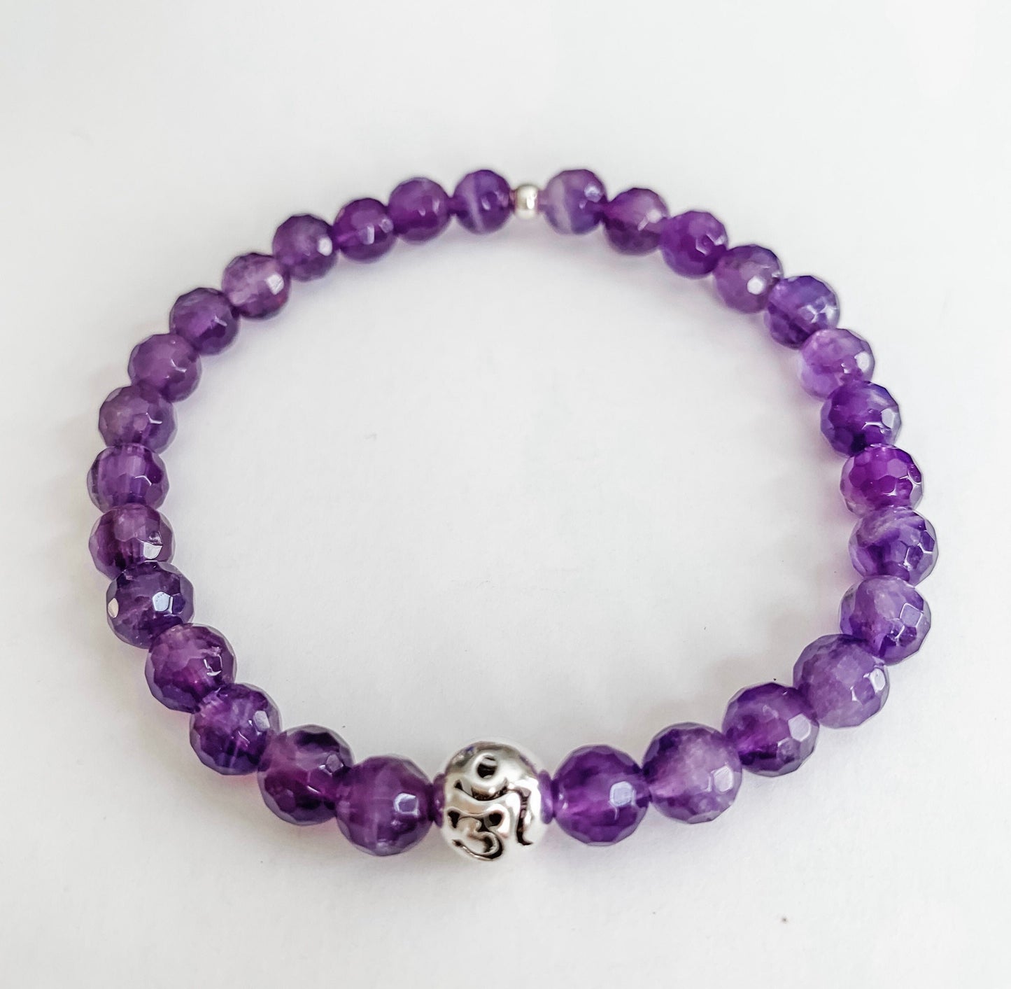 Amethyst beaded bracelet with sterling silver Om round ball bead charm