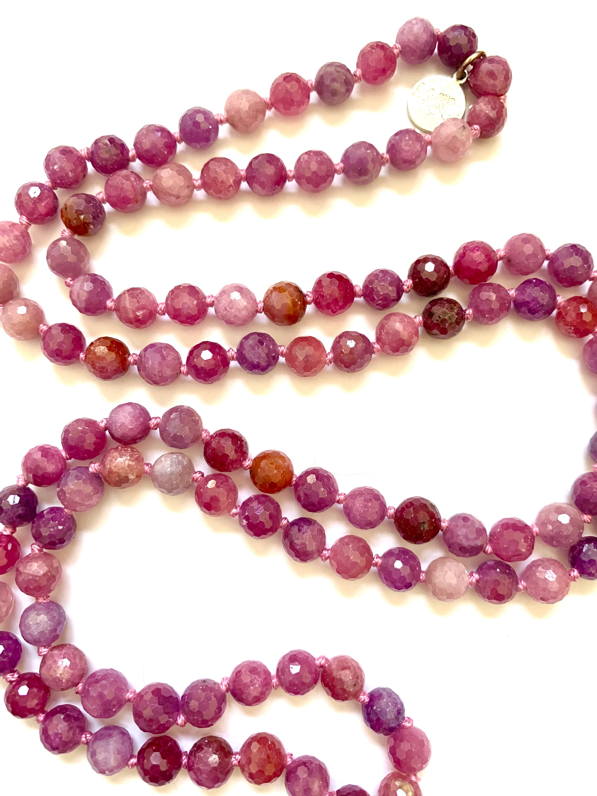 close up of ruby mala beads, knotted 6mm